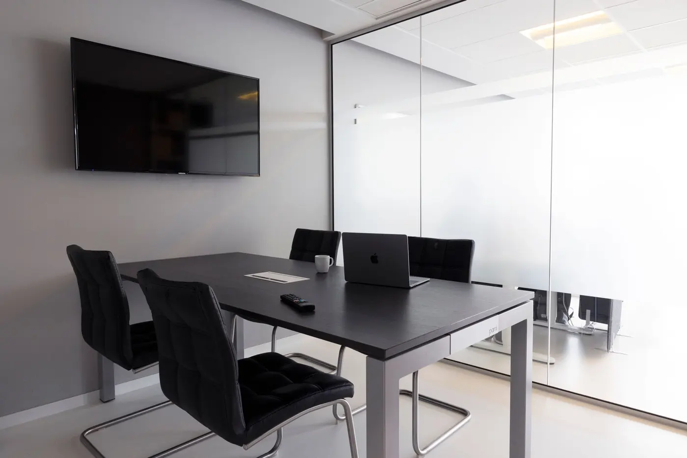 Stock photo: meeting room with a wall mounted display and empty chairs
