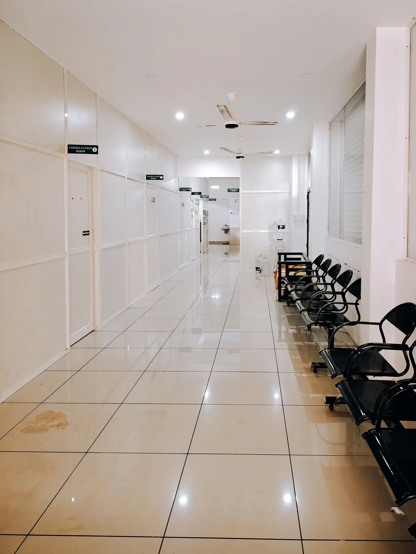 Stock photo: bright clinic corridor with a row of empty chairs