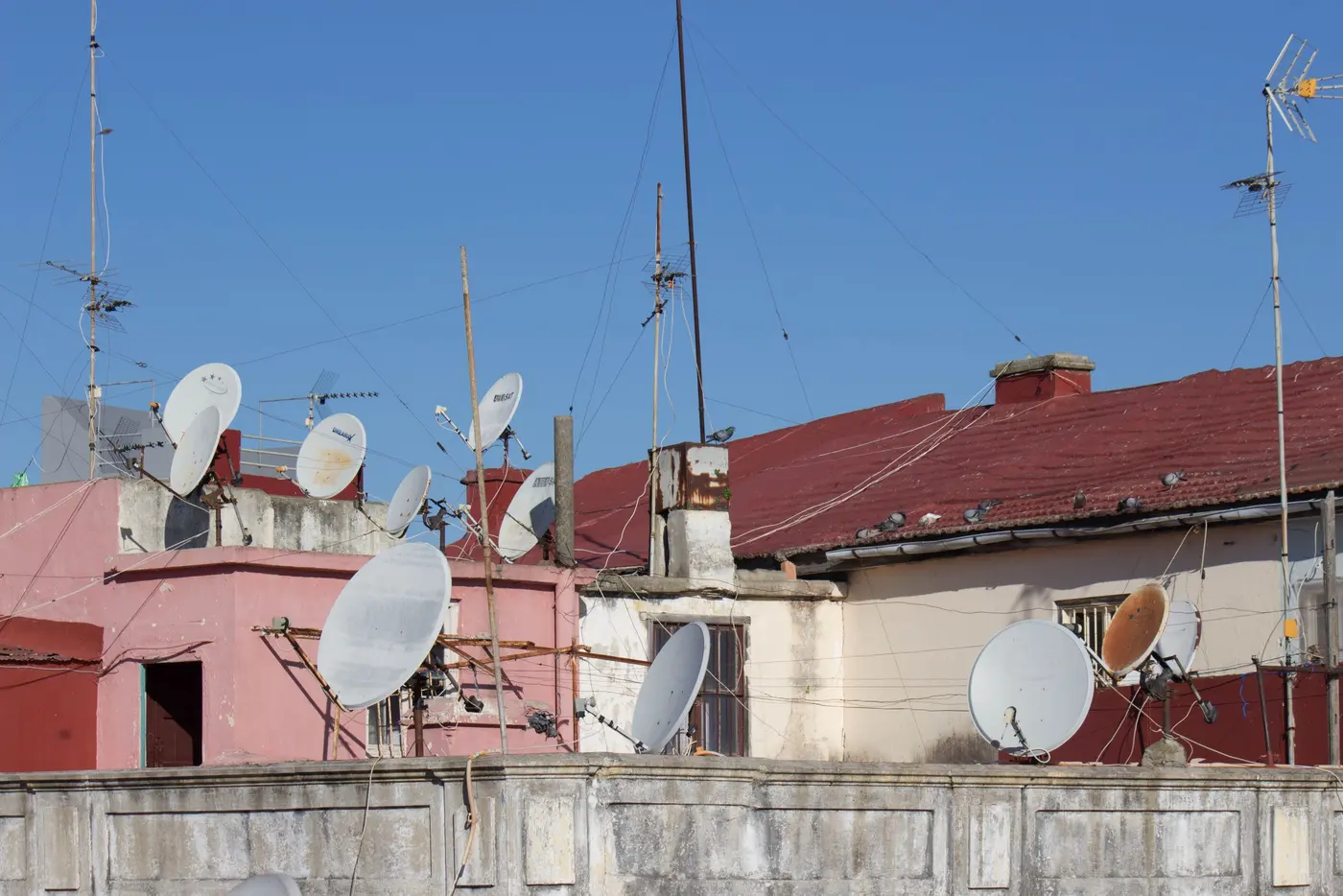 Stock photo: rooftops with several satellite dishes mounted
