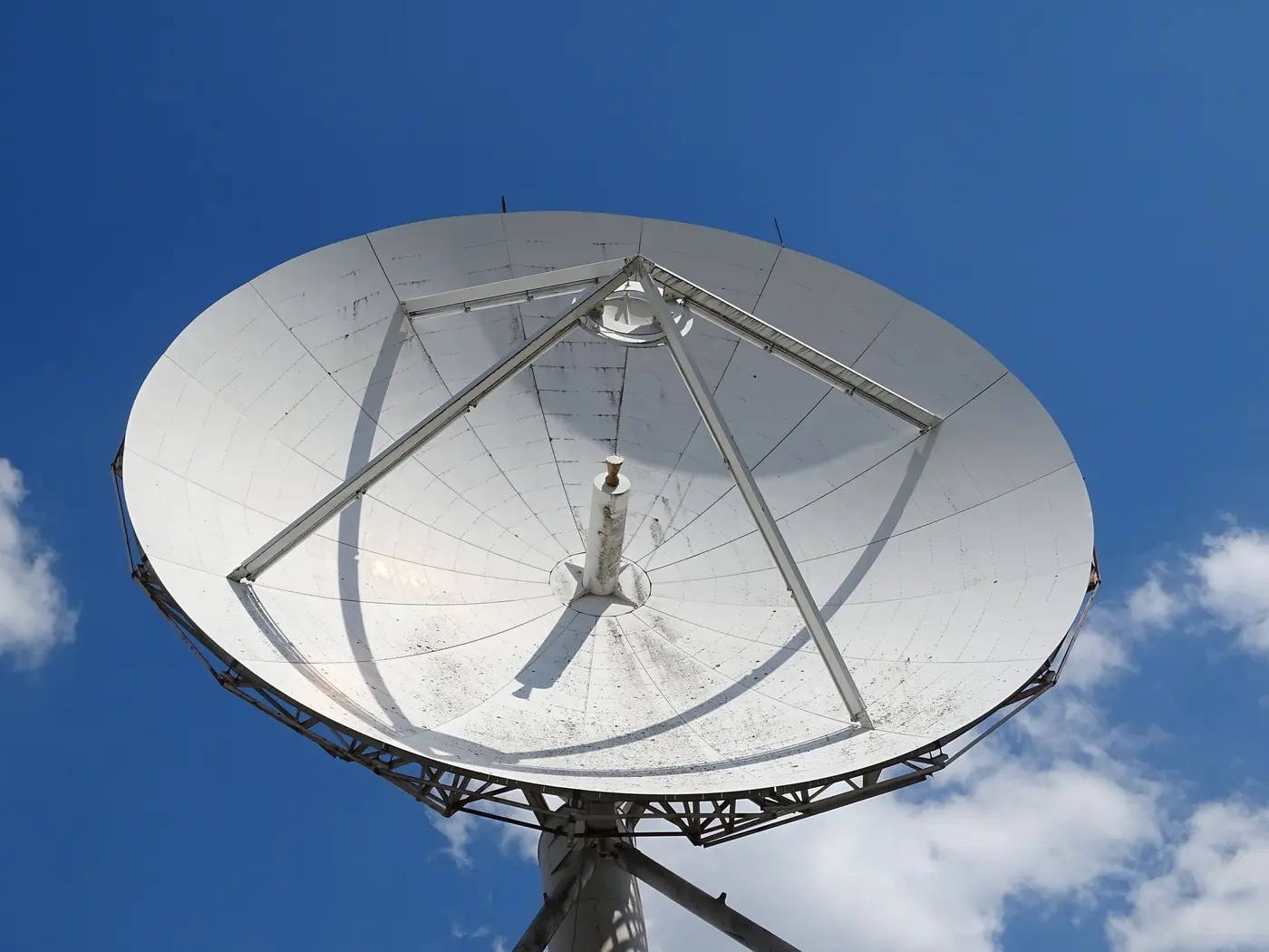 Stock photo: white satellite dish against a clear blue sky