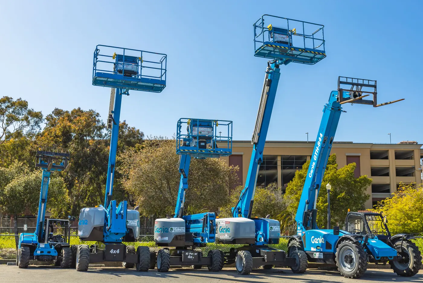 Stock photo: row of blue boom lifts parked on a job site