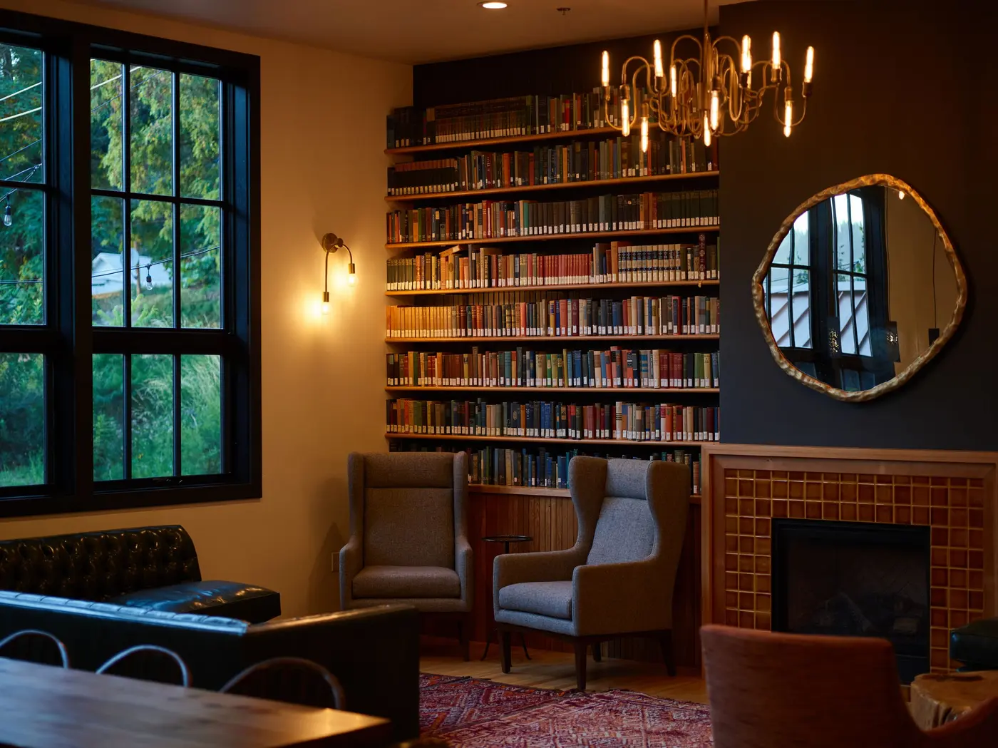 Stock photo: common room with armchairs, bookshelves and a fireplace