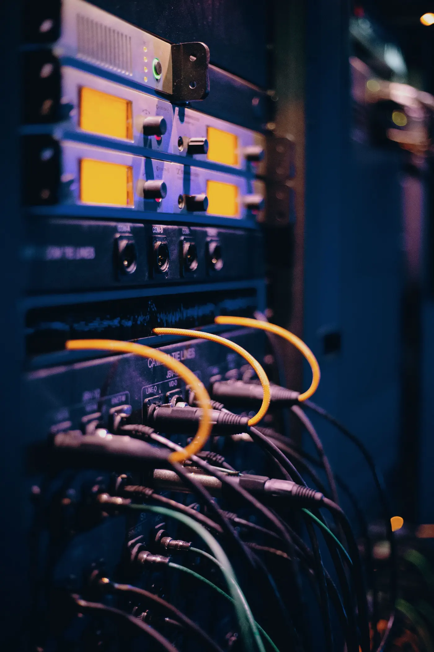 Stock photo: rack equipment with yellow patch cables connected in low light
