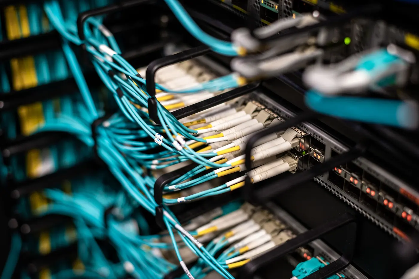 Stock photo: patch cables routed into rack panels in an equipment room
