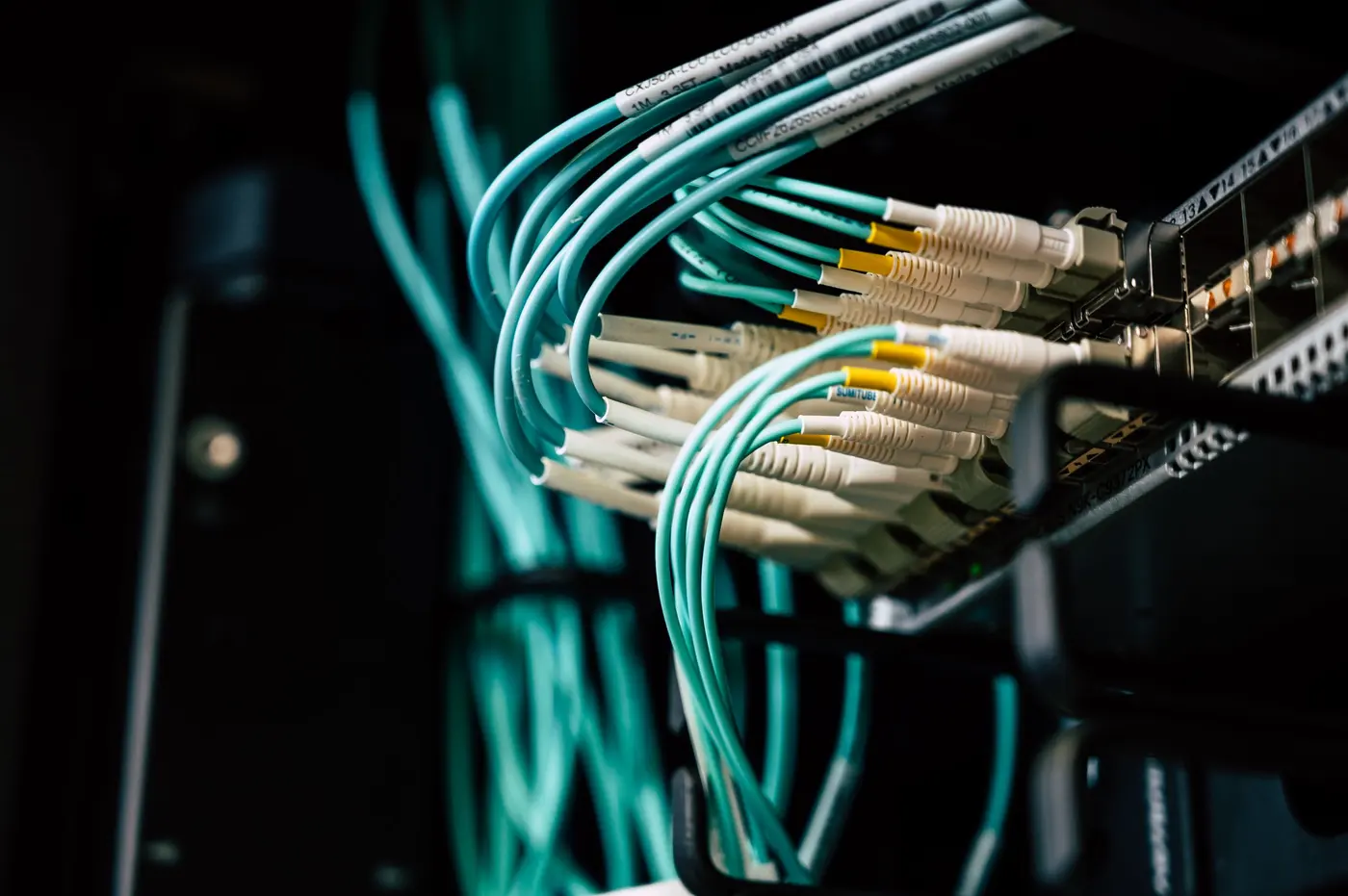 Stock photo: teal network cables dressed into a rack mounted panel