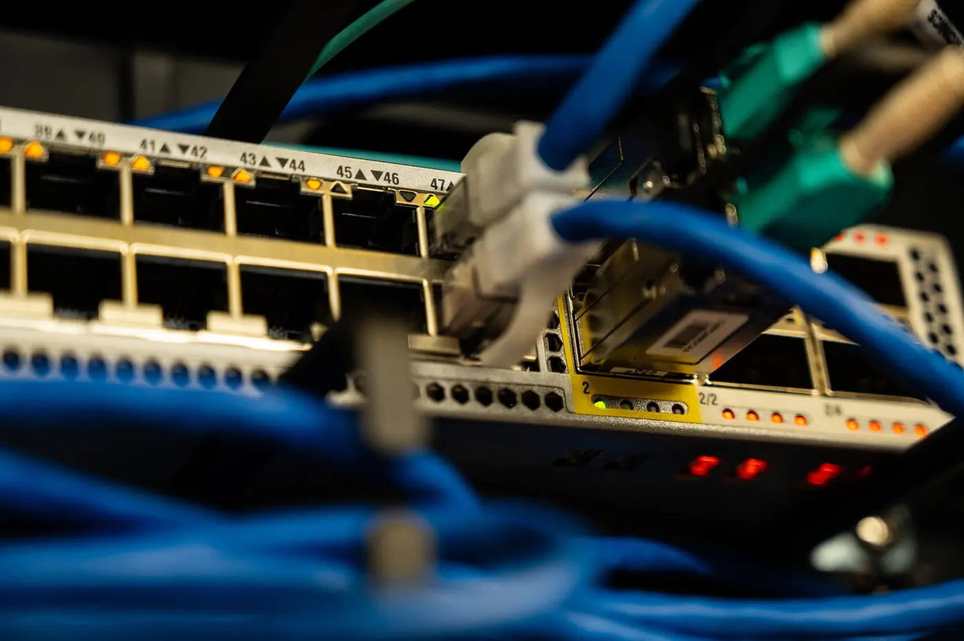Stock photo: blue network cables plugged into a rack mounted switch