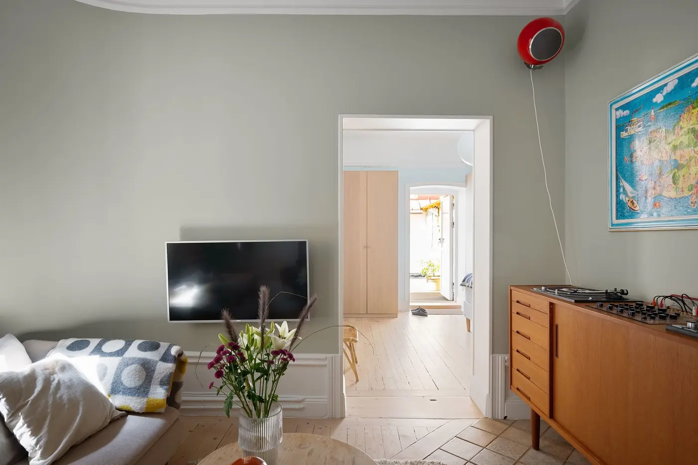 Stock photo: wall mounted TV above cabinets in a furnished room