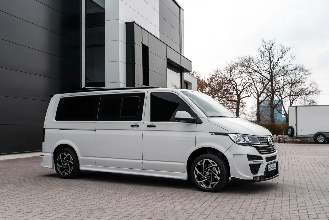 Stock photo: white work van parked outside a modern building