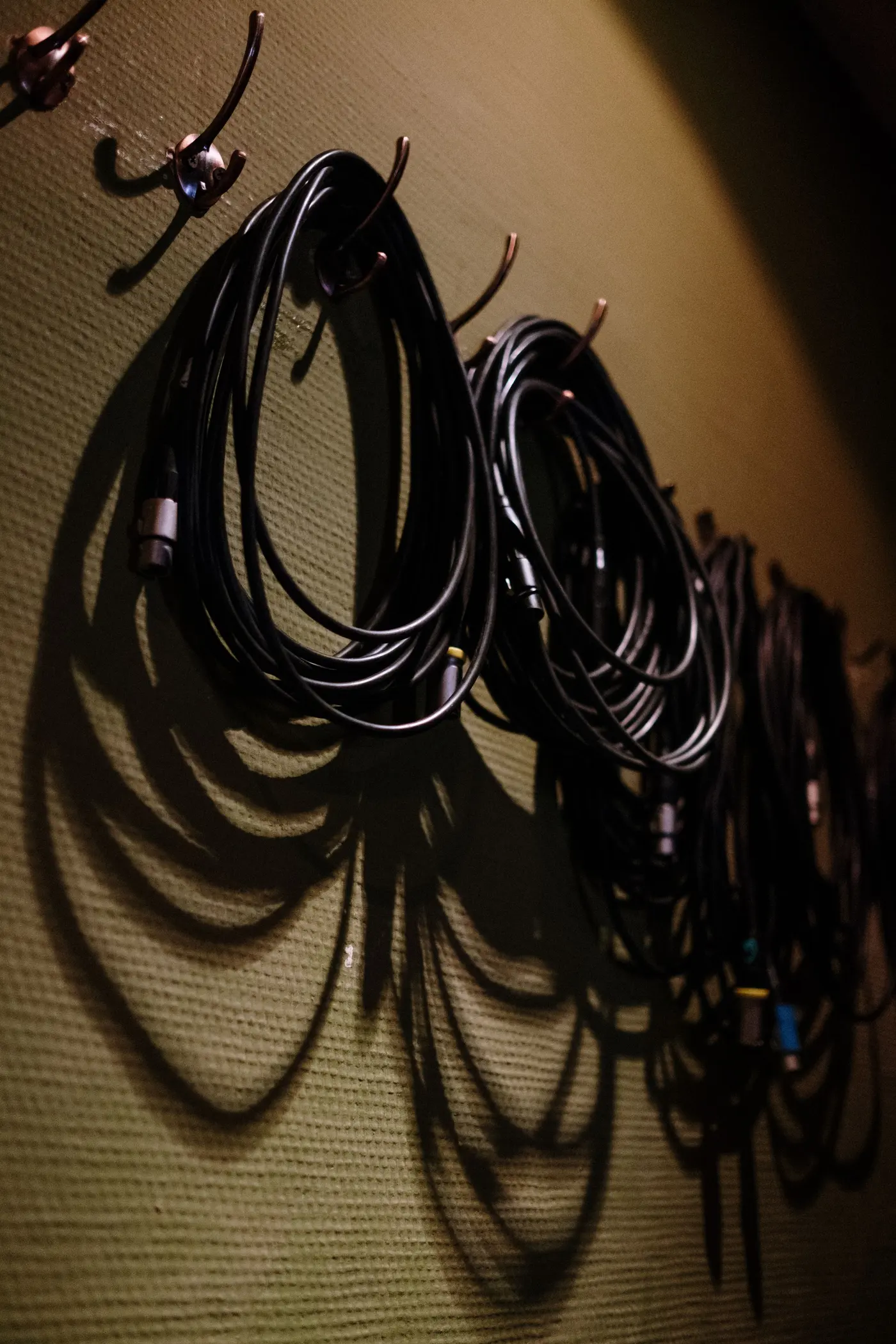 Stock photo: coiled cables hanging on wall hooks